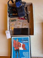 Box view showing camera, watches, knives, coins, stamp album