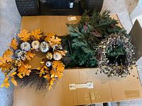 Three wreaths arranged on top of tree box