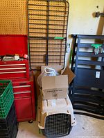 Crate, adjustable gate, box with accessories grouped together