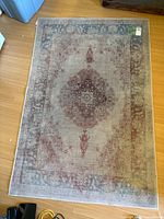 Full view of rectangular faded rug