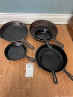 Five skillets of varying sizes with one nested