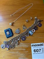 Group shot of bracelet, necklace, earrings and loose charms