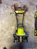 Top view of Sun Joe TJ603E tiller with cord and wheels visible