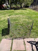 Overall view of assembled metal wire enclosure in yard