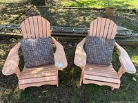 Front view of both peach wooden Adirondack chairs with cushions, showing overall design and wear