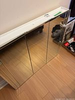 Front angle view showing mirrored doors and white frame