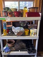 Full shelving unit with assorted garden items