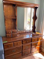 Full view of dresser showing mirror, shelving, drawers, brass hardware