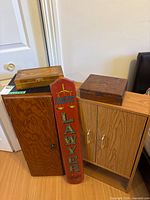 Group view of both cabinets, two wooden boxes, red Lawyer sign