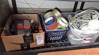 Lot overview showing tapes, cords and box of small tools