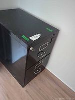 Angled view of entire cabinet showing two drawers, lock, and key