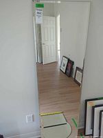 Front view of full-length mirror leaning against wall