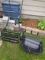 Full view of mower and grass catcher on lawn