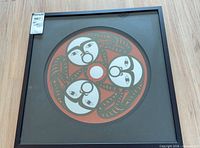 Full view of framed serigraph print in black metal frame