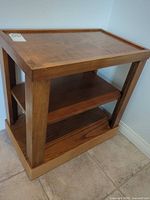 Full view of side table showing top, shelves, legs, finish