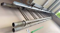 Side view of aluminum extension ladder mounted on wall, shows overall structure and length