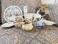 Group shot of all ten dinnerware pieces on fabric background