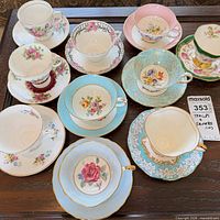 Top view of all ten teacup and saucer sets showing patterns and colors