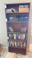 Front view of tall brown cherry 5-shelf bookcase