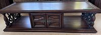 full view of coffee table showing top, storage cabinet and open shelf