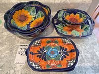 Nested scalloped bowls, stack of small bowls and one rectangular platter