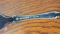 Handle reverse showing International Sterling hallmark and ornate detailing