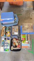 overview of multiple plastic bins containing organizers, paint supplies, hardware