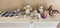 Full lot overview on shelf showing all ceramics and figurines