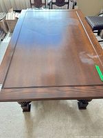 Top view of oak dining table showing framed panel surface and finish wear