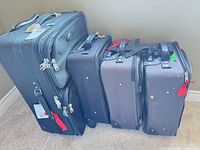 Four suitcases grouped together showing sizes and colors