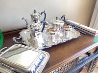 Full view of tray, tea/coffee service pieces, covered dish and boxed carving knife