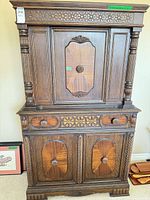 Full front view of carved wood hutch cabinet closed