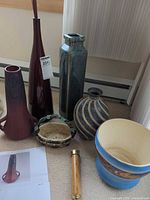 Group shot of all seven items: four vases, planter bowl, shallow bowl, wooden handle