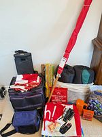 Group view of all items including coolers, sleeping bags, towels, flag, pole
