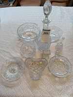 Overall view of decanter, bowls, heart dish, bell and plates
