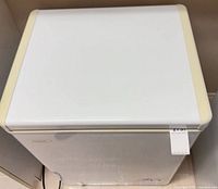 Top view of closed chest freezer showing yellowed corners