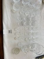 Overview of stem glasses, pitcher and small bowl on table