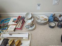 Group shot: plates, cups, saucers, figurines, chopsticks, coasters, paper items