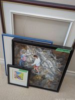 Group view of all three items: large empty burgundy frame with mat, blue inner mat, framed painting, framed print