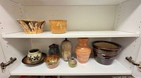 Full shelf view showing all nine ceramic pieces