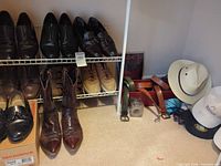 Shelved dress shoes, cowboy boots, belts, hats