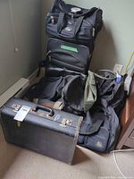 Group view of all bags: rolling suitcase, hard suitcase, soft bags, pouch