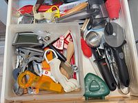Drawer of assorted small utensils and timer