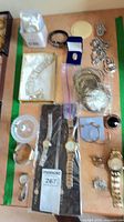 Overview of entire lot showing multiple jewelry pieces and watches