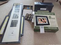 Group shot of all items including digital frame box, wall collage frame, small tabletop frames, albums and storage box