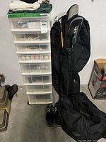 Overall lot: drawer tower, golf bag with clubs, shoes