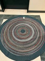 Full view of round braided rug showing pattern and colors