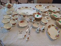 Overhead view of complete Royal Albert Old Country Roses service laid out on table