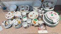 Full layout of dinnerware pieces stacked and grouped on countertop