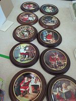 All 11 round Santa plaques displayed on floor